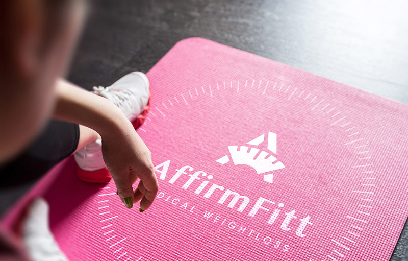 AffirmFitt logo on yoga mat